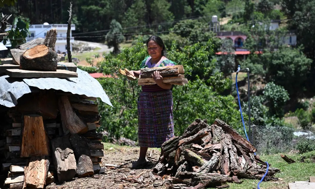 Indigenous woman Cecilia Pasa, 38, loads firewood at her house in the Xetzac community of Cunen, Quiche department, Guatemala, on May 27, 2026. —AFP