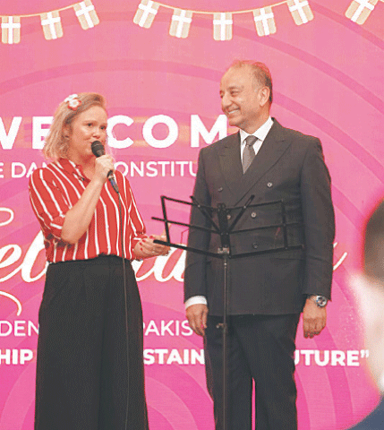 Danish Ambassador Maja Derrous Mortensen speaks at a reception held on the occasion of Denmark’s Constitution Day in Islamabad on Saturday. Minister for Climate Change Dr Musadaq Malik is also present. — Dawn