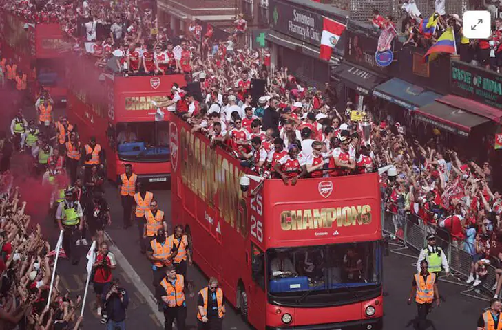 Arsenal players celebrate with the English Premier League trophy during the victory parade in London on May 31 | Reuters