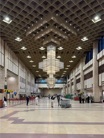   Based on the building&rsquo;s modular grid, the patterns repeat at varying scales while maintaining a visual coherence. This is visible in the check-in hall, where acoustic considerations led to integration of local material culture | Benoit Floren&ccedil;on  