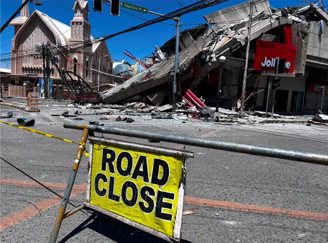 road closure signage is placed near a collapsed building in General Santos, Philippines.—Reuters