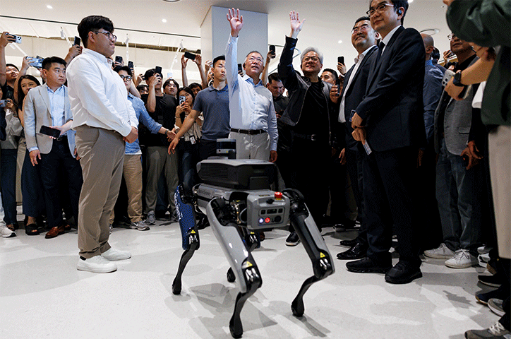JENSEN Huang, the chief executive of Nvidia, and Hyundai Motor Group’s executive chair Chung Eui-sun look at a robot on display at Hyundai headquarters in Seoul.—Reuters