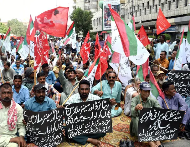 KWSC workers stage a sit-in outside the Karachi Press Club on Wednesday. —Shakil Adil / White Star