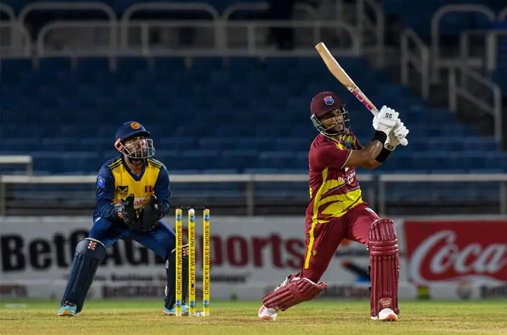 KINGSTON: West Indies captain Shai Hope plays a lofted shot as his Sri Lankan counterpart Kusal Mendis watches during the first Twenty20 International at the Sabina Park.—AFP