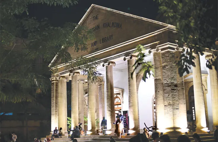 People outside the Khalikdina Hall on a breezy Karachi evening: after KMC’s approval, an interdisciplinary group called Numaish Collective applied and won a British Council grant under UK’s Cultural Protection Fund, which enabled them to carry out four months of renovation in 2024 | Faisal Farooqi