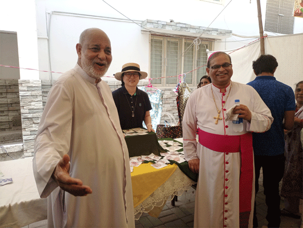 Reverend Father Arthur Charles (left) and Bishop Benny Mario Travas visit an artificial jewellery stall during the fair.—Photo by the writer