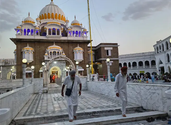 Sikh pilgrims leave Gurdwara Panja Sahib in Hassanabdal on Sunday. — Dawn