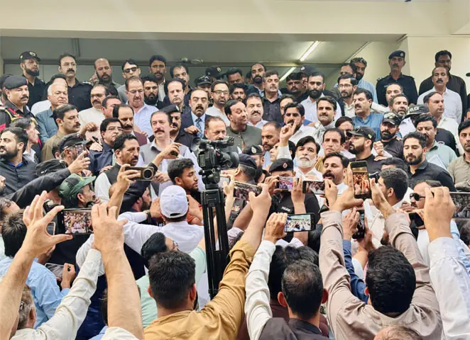 Flanked by some of his ministers, AJK Prime Minister Faisal Mumtaz Rathore addresses a gathering of ad hoc and temporary employees at the entrance of the assembly which passed two bills to regularise their jobs. — Dawn