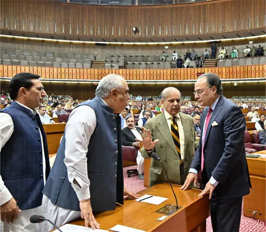 PM Shehbaz Sharif confers with Finance Mini&shy;ster Muha&shy;mmad Aurangzeb as they chat with PTI leaders Asad Qaiser and Barrister Gohar during the NA session.&mdash;FB/NationalAssemblyOfPakistan
