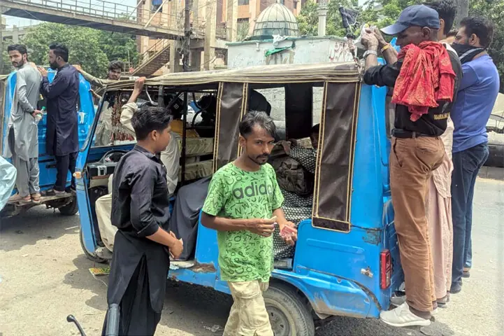 The transporters’ strike forces passengers to cling to the backs of overcrowded rickshaws despite imminent danger. —PPI