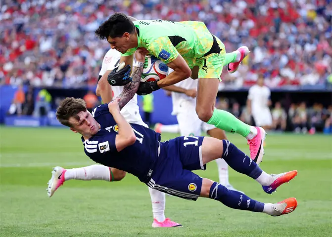 FOXBOROUGH: Morocco goalkeeper Yassine Bounou and Ben Gannon-Doak of Scotland collide during their Group ‘C’ match at the Boston Stadium.—AFP