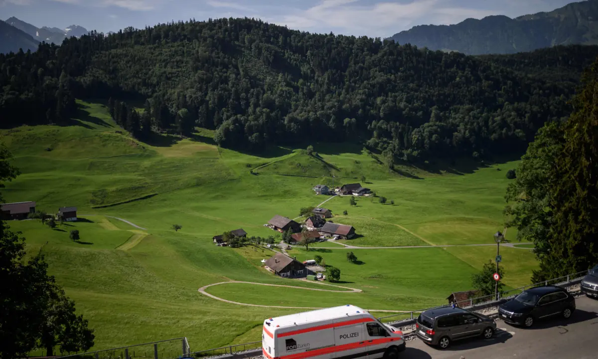 A police car is parked near a hamlet close to the Burgenstock luxury hotel complex overlooking Lake Lucerne, Switzerland, on June 21, 2026. ─ AFP