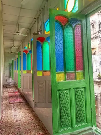 Glass windows in Imambargah Col Maqbool Hussain reflect the Anglo-Indian building style of the British era.