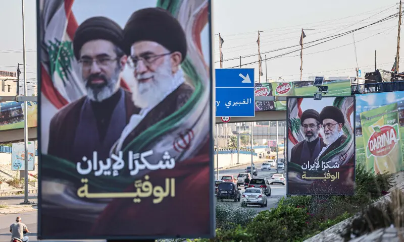  Cars and motorbikes drive past billboards showing Iran&rsquo;s new Supreme Leader Ayatollah Mojtaba Khamenei (L) and his late father Ali Khamenei (R), with the slogan &ldquo;Thank you, loyal Iran,&rdquo; erected along the highway leading to Rafic Hariri International Airport in Beirut on June 22 &mdash; AFP 