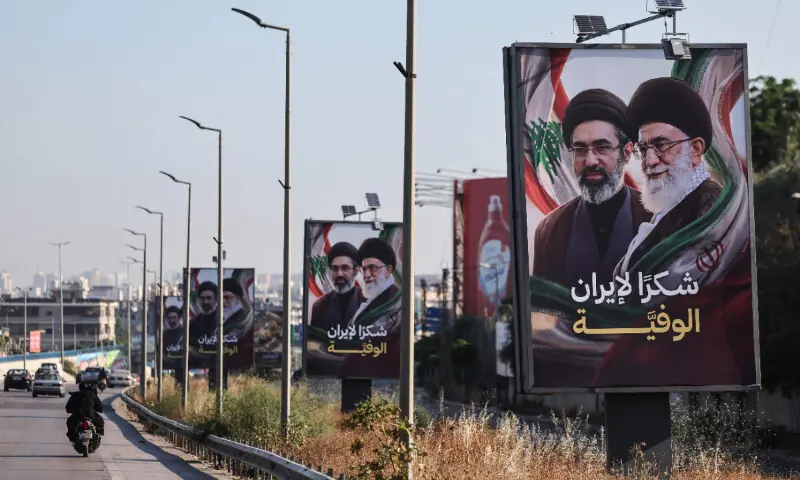  Cars and motorbikes drive past billboards showing Iran&rsquo;s new Supreme Leader Ayatollah Mojtaba Khamenei (L) and his late father Ali Khamenei (R), with the slogan &ldquo;Thank you, loyal Iran,&rdquo; erected along the highway leading to Rafic Hariri International Airport in Beirut on June 22 &mdash; AFP 