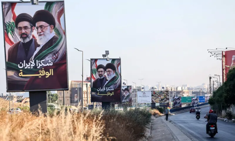 Cars and motorbikes drive past billboards showing Iran&rsquo;s new Supreme Leader Ayatollah Mojtaba Khamenei (L) and his late father Ali Khamenei (R), with the slogan &ldquo;Thank you, loyal Iran,&rdquo; erected along the highway leading to Rafic Hariri International Airport in Beirut on June 22 &mdash; AFP 