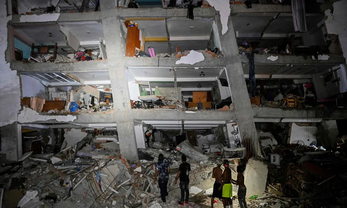 People stand in the rubble near a damaged building following an earthquake in Catia La Mar, La Guaira State, some 30kms north-west of Caracas, early on June 25, 2026. &mdash;AFP