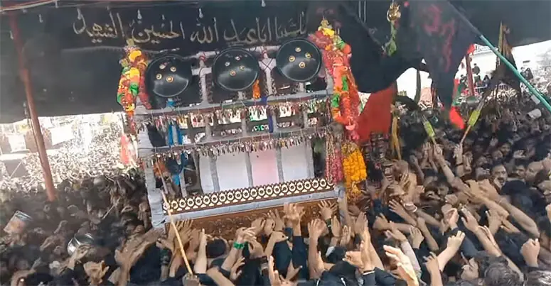  PARTICIPANTS of the procession try to touch the Nau Dhaala Tazia in Rohri on Thursday.&mdash;Dawn 