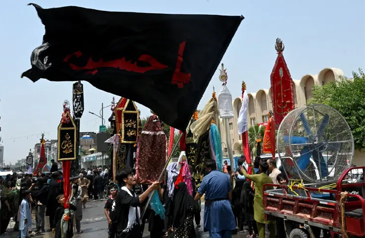  A fan being used to facilitate mourners during the 9th Muharram procession in Peshawar. &mdash; AFP 