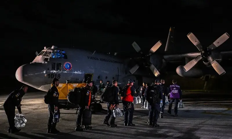 Colombian firefighters carrying bottles of water prepare to board a Colombian Air Force plane with humanitarian aid to Venezuela at Catam Air Base in Bogota on June 26, 2026, following deadly earthquakes. &mdash;AFP