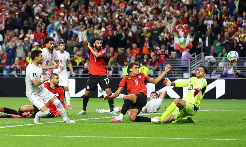  SEATTLE: Iran&rsquo;s Shoja Khalilzadeh (L) scores a goal past Egypt goalkeeper Mostafa Shoubir that was later disallowed during their Group &lsquo;G&rsquo; match at the Seattle Stadium.&mdash;Reuters 