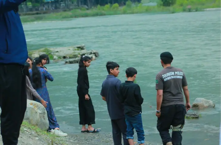  Policemen try to keep young tourists away from the Kunhar River near Naran in Kaghan Valley. &mdash; Dawn 