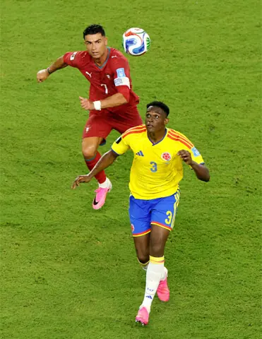   MIAMI GARDENS (Florida): Colombia&rsquo;s Jhon Lucumi (R) in action with Portugal&rsquo;s Cristiano Ronaldo during their Group &lsquo;K&rsquo; match at the Miami Stadium.&mdash;Reuters  