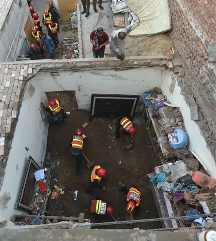 Rescue workers comb the debris for signs of life after a roof collapse buried dozens of students at a tuition centre in the Kahna area of Lahore.—Murtaza Ali / White Star