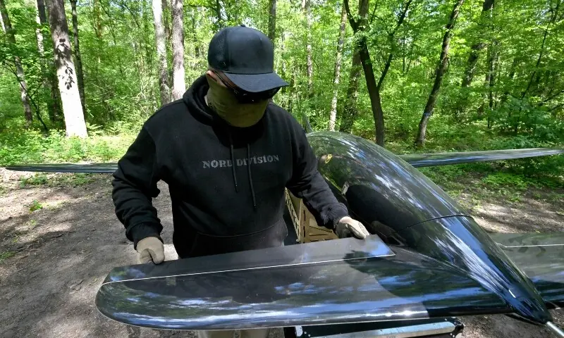 This photograph, taken at an undisclosed location in Ukraine on May 16, 2026, shows a Ukrainian serviceman of the Main Directorate of Intelligence of the Ministry of Defence of Ukraine, callsign "Wolf", working on a Bober or