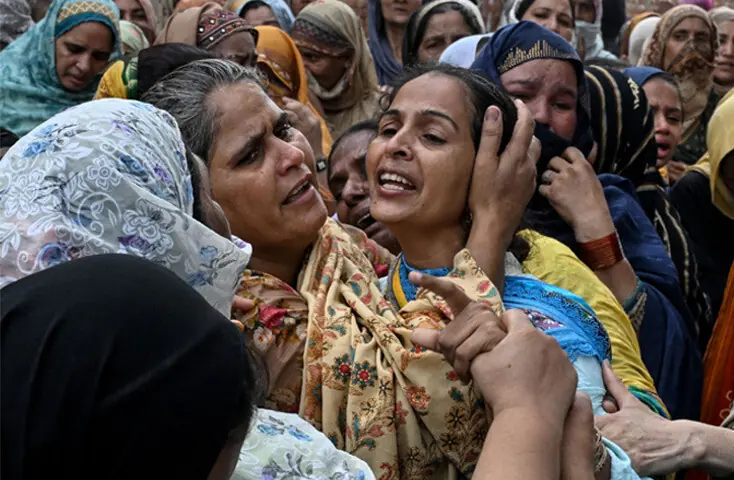 RELATIVES comfort the mother of one of the children, who perished when the roof of their tuition centre collapsed, during their funeral in Lahore’s Kahna area.—AFP