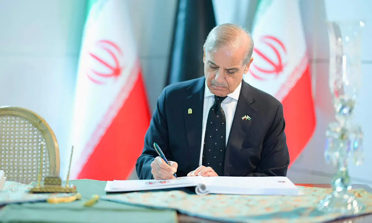 Prime Minister Shehbaz Sharif writing in the condolence book during the state funeral of Iran’s late supreme leader Ayatollah Ali Khamenei in Tehran. — AFP