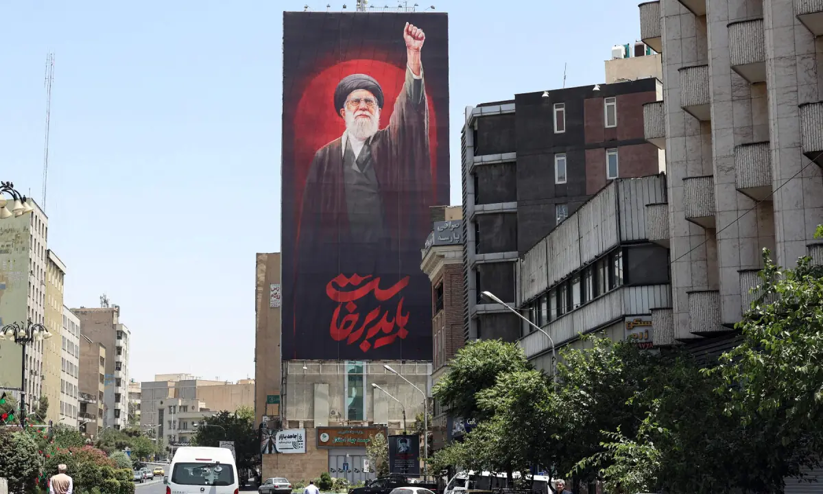 Motorists drive past a billboard bearing a picture of Iran’s assassinated supreme leader Ali Khamenei, ahead of his funeral in Tehran on July 3, 2026. — AFP