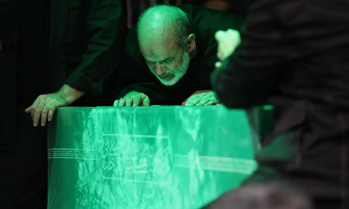 This handout photograph provided by the Iranian supreme leader office (Khamenei.IR) shows the chief of Iran’s Revolutionary Guards, Ahmad Vahidi (C) paying respect at the coffin of Iran’s slain supreme leader Ali Khamenei during a ceremony ahead of his funeral in Tehran on July 3, 2026. — AFP
