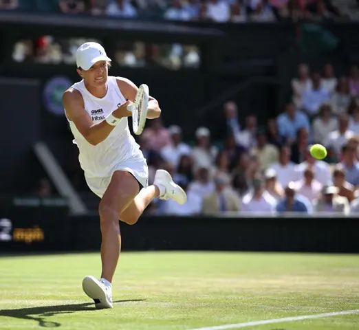 Poland’s Iga Swiatek returns a shot to Alexandra Eala of the Philippines during their Wimbledon third-round match at The All England Lawn Tennis and Croquet Club on Saturday.—AFP