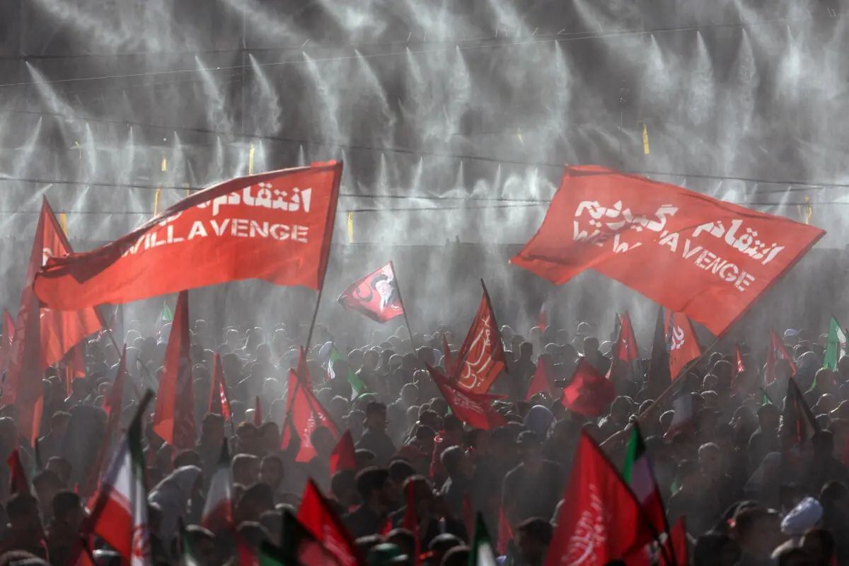 Mourners wave flags under water sprinklers during a public farewell ceremony to pay their respects to late supreme leader Ayatollah Ali Khamenei who was killed on February 28 in Israeli and US airstrikes, at the Imam Khomeini Grand Mosalla, in Tehran, Iran, July 5, 2026. &mdash; Reuters