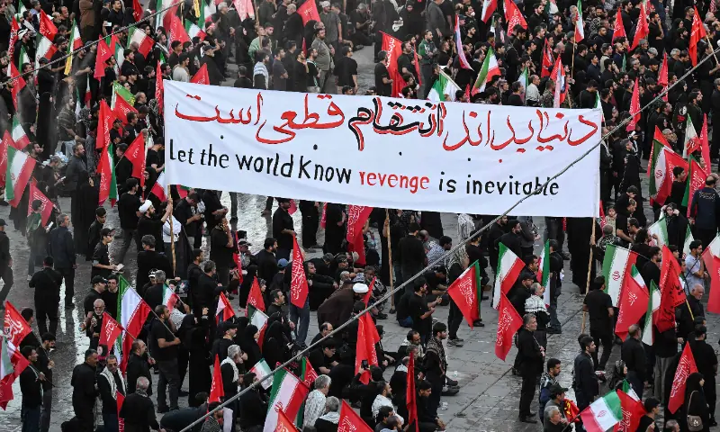  People hold up a revenge banner as they gather to mourn Iran&rsquo;s assassinated supreme leader Ayatollah Ali Khamenei at the Grand Mosalla on the second day of funeral ceremonies in Tehran on July 5, 2026. &mdash; AFP 