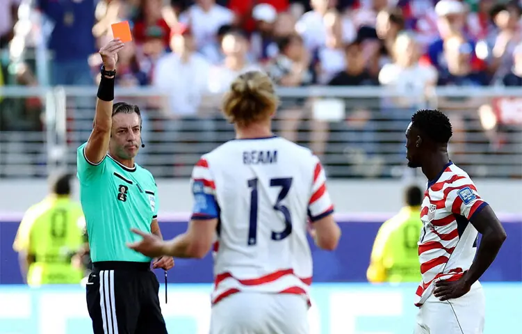  Striker Folarin Balogun (right) is shown a red card during America&rsquo;s match against Bosnia.&mdash;Reuters 