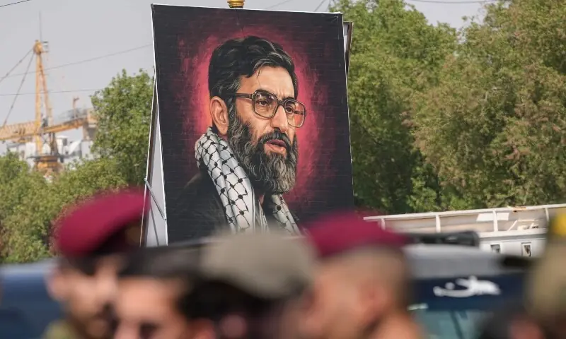 Security forces stand on a street in front of a banner depicting Iran&rsquo;s slain supreme leader Ali Khamenei in Najaf on July 7, 2026, a day before his funeral procession in the holy Iraqi city. &mdash;AFP