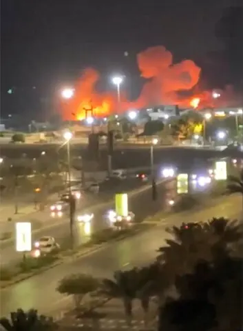 Smoke and flames rise after an explosion in the port of Bandar Abbas.—Reuters / Centcom