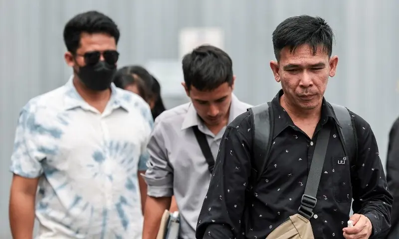 Panithi Tumkaew, Noppadon Wongsuvan and Surades Manpuen, Thai crew members of the cargo ship Mayuree Naree, walk after the Central Labour Court accepts a lawsuit accusing Thailand-based company Precious Shipping of ordering the vessel to sail through the waterway despite military tensions between the US and Iran, in Bangkok, Thailand on July 10, 2026. &mdash;Reuters
