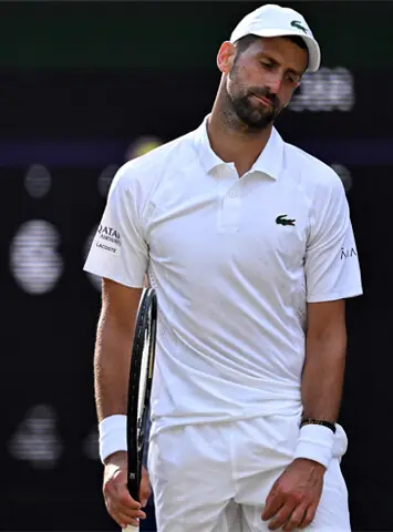 SERBIA’S Novak Djokovic reacts during his Wimbledon semi-final against Jannik Sinner of Italy at The All England Lawn Tennis and Croquet Club on Friday.—AFP