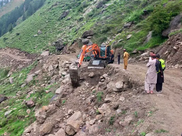 A machine clears the Bala Manoor-Biyari Manoor Road to restore access for four-wheel traffic in Manoor Valley, Mansehra, which remained closed for seven months due to flash floods and landslides. — Dawn