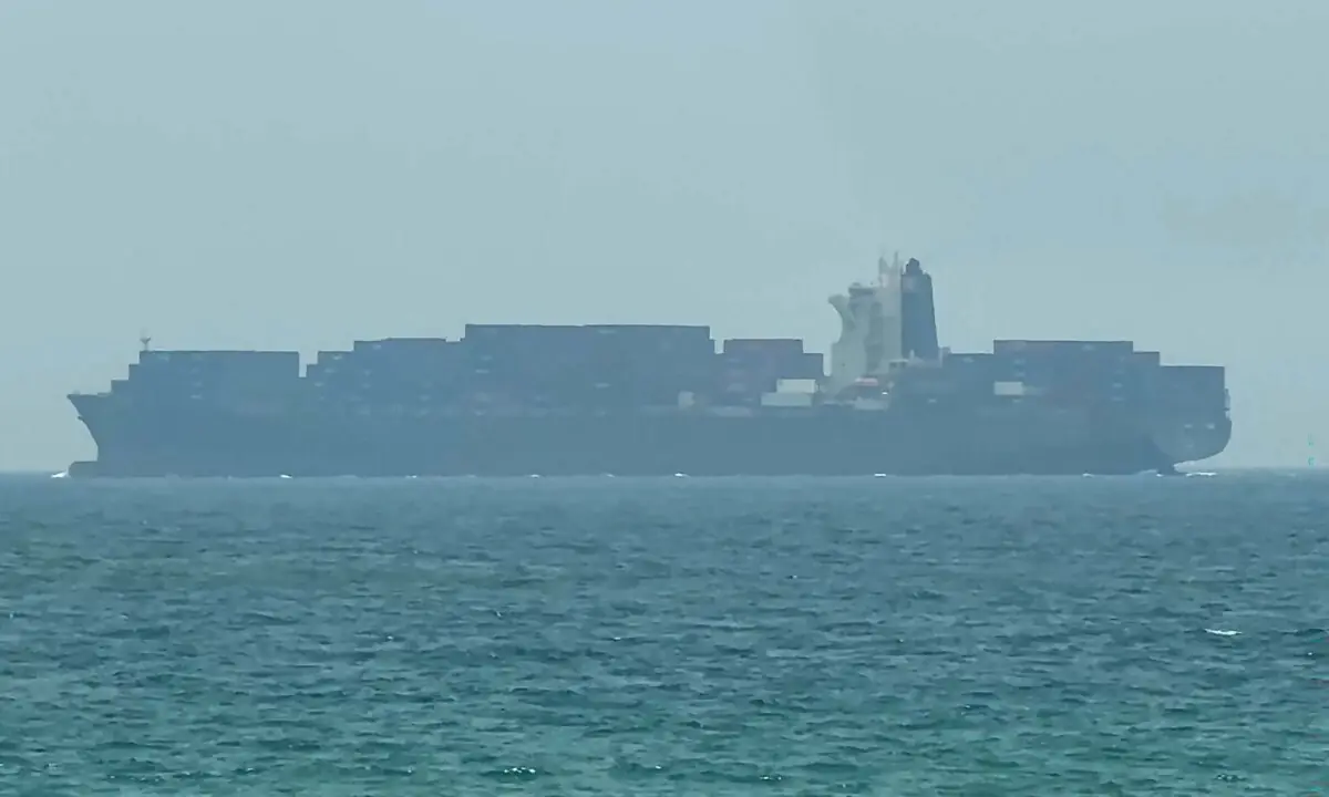 This frame grab taken from AFPTV video footage on July 12, 2026 shows a cargo ship anchoring near the Strait of Hormuz off the eastern coast of the United Arab Emirates at Khor Fakkan. — AFP