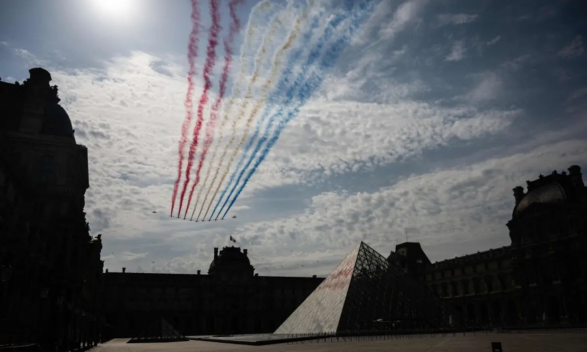 France&rsquo;s Air Force Elite aerobatic flying team &ldquo;Patrouille de France&rdquo; (PAF) releases trails of France&rsquo;s national colours as they perform a flyover during the annual Bastille Day military parade on the Court Carre with the Louvre Pyramid, designed by Chinese-US architect Ieoh Ming Pei and the Louvre Museum in Paris on July 14, 2026. &mdash;AFP