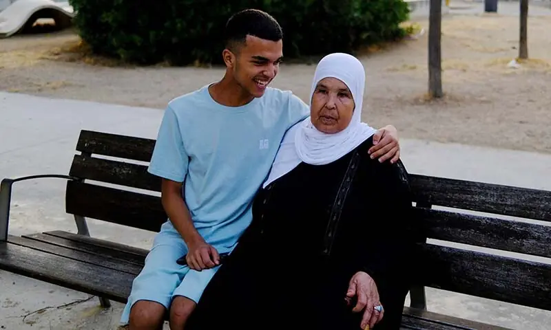 Lamine Yamal’s grandmother, Fatima Nasraoui, and his cousin Rayan, 15, sit on a bench at a park in Rocafonda neighbourhood in Mataro, north of Barcelona, Spain on July 16, 2026. — Reuters
