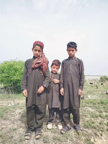 Young shepherds pose for a photograph near Arar Mughlan Dam.