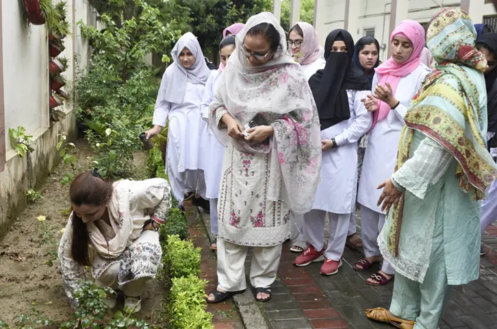  A participant plants a sapling during a tree plantation campaign organised by the Rising Pakistan Forum at the Women Welfare and Development Centre in Islamabad on Wednesday. &mdash; Photo by Tanveer Shahzad 