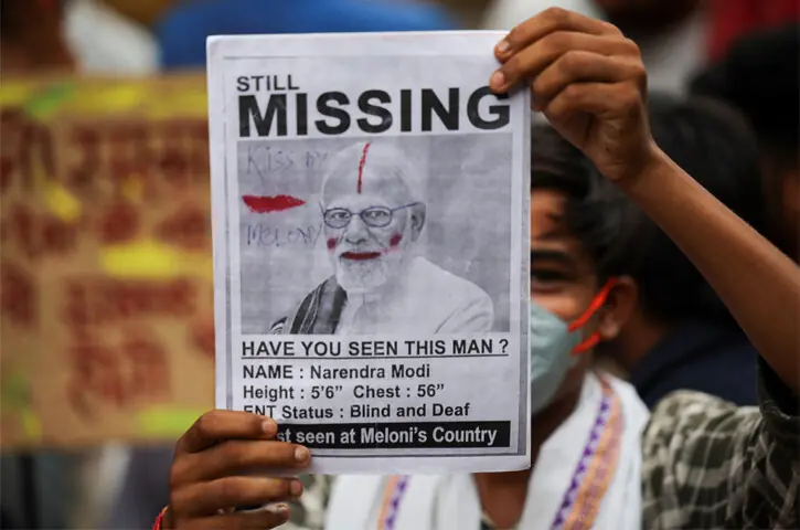 A supporter of India’s Cockroach Janta Party holds up a poster featuring a ‘missing’ ad for Indian PM Narendra Modi during ongoing protests in New Delhi.—Reuters / AFP