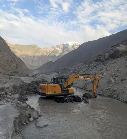  GILGIT: Heavy machinery clears debris after a portion of the Karakoram Highway was washed away by rain and landslides in the Jaglot Gouro area.&mdash;Dawn  