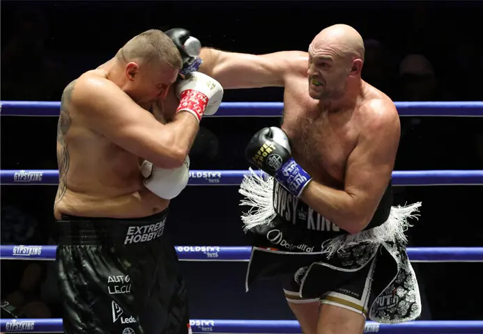 BRITAIN’S Tyson Fury lands a punch on Mariusz Wach of Poland during their charity bout at the Max Muay Thai Stadium.—Reuters